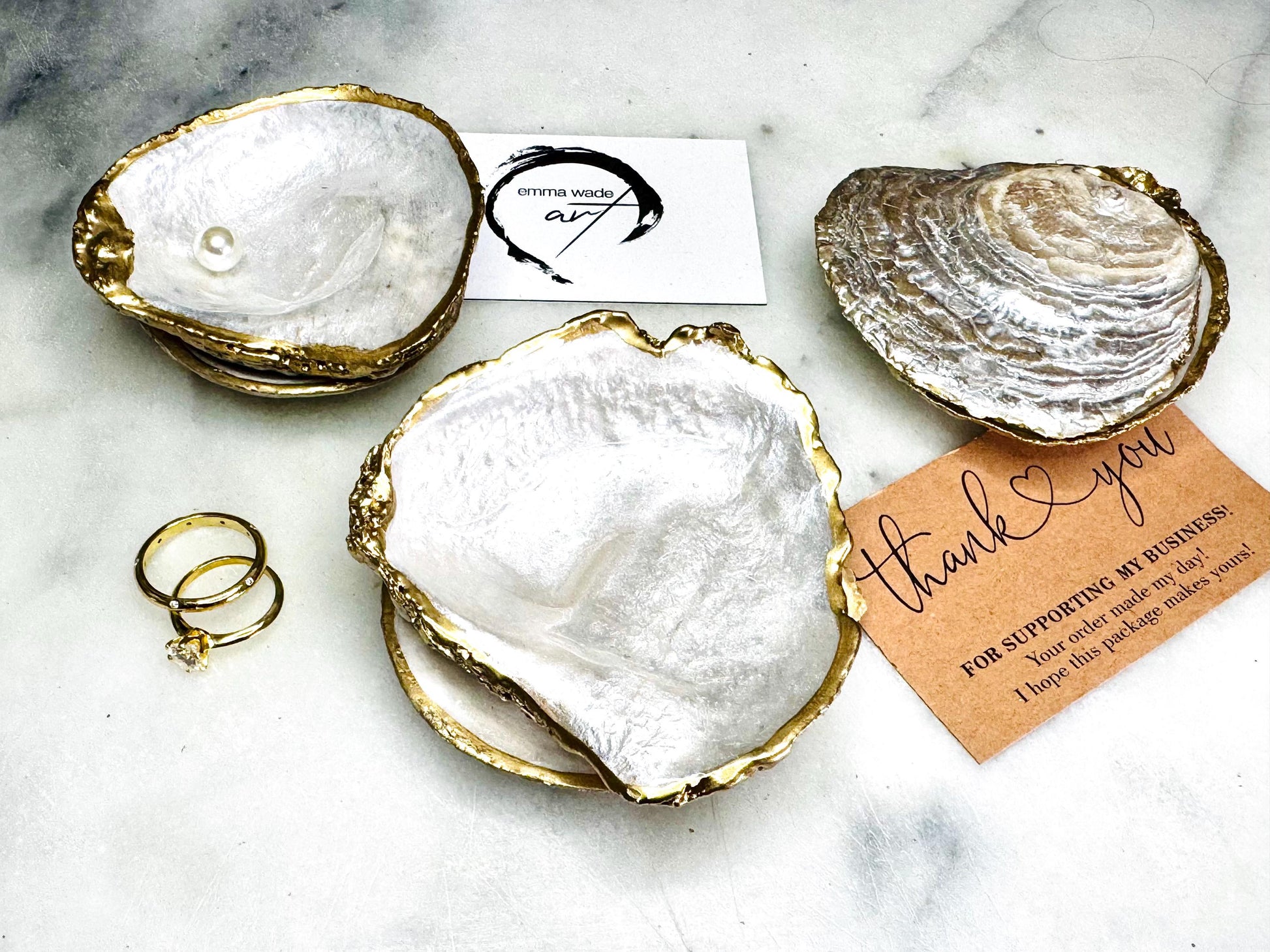 Handcrafted saddle oyster shell ring box with pearlescent finish inside and outside, gold leaf gilded edges and optional Swarovski pearl inset, coastal wedding ring bearer box, engagement proposal ring holder, luxury shell jewellery dish, unique handmade UK gift on marble backdrop
