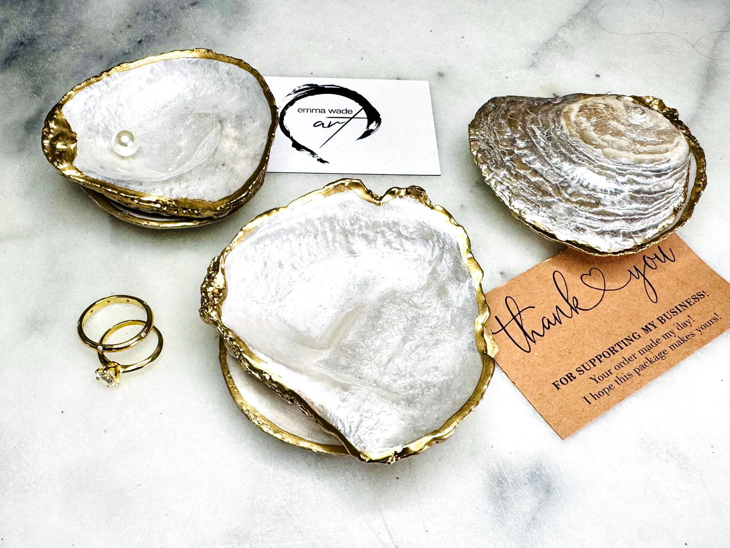 Handcrafted saddle oyster shell ring box with pearlescent finish inside and outside, gold leaf gilded edges and optional Swarovski pearl inset, coastal wedding ring bearer box, engagement proposal ring holder, luxury shell jewellery dish, unique handmade UK gift on marble backdrop