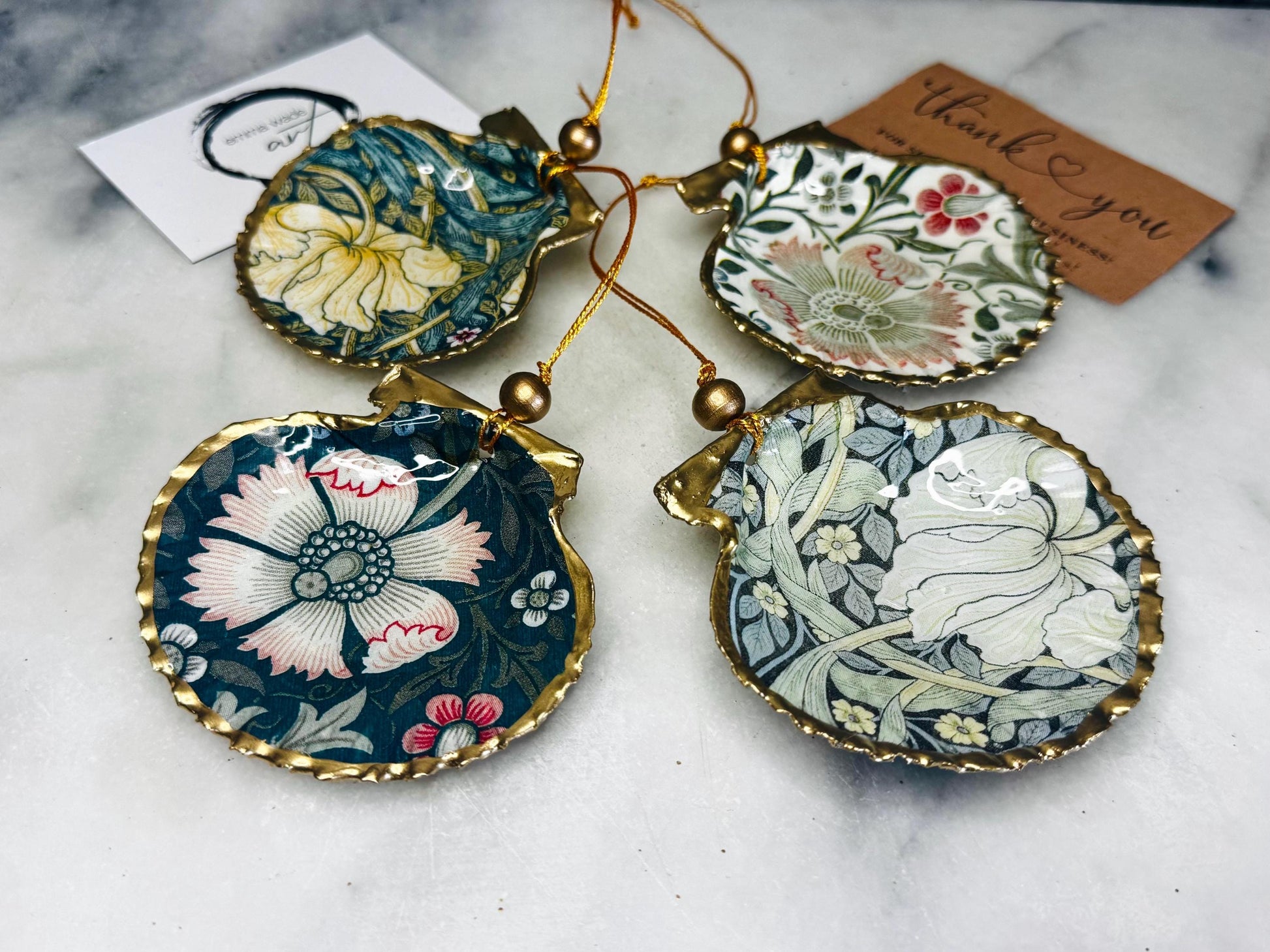 William Morris scallop shell ornaments sold individually or as set of 4, handmade Dorset shells with gold leaf gilded rims and backs, glossy resin interiors, Compton and Pimpernel floral designs, coastal hanging decorations with gold string, sustainable handmade gift, coastal home decor, Christmas ornament or unique shell gift