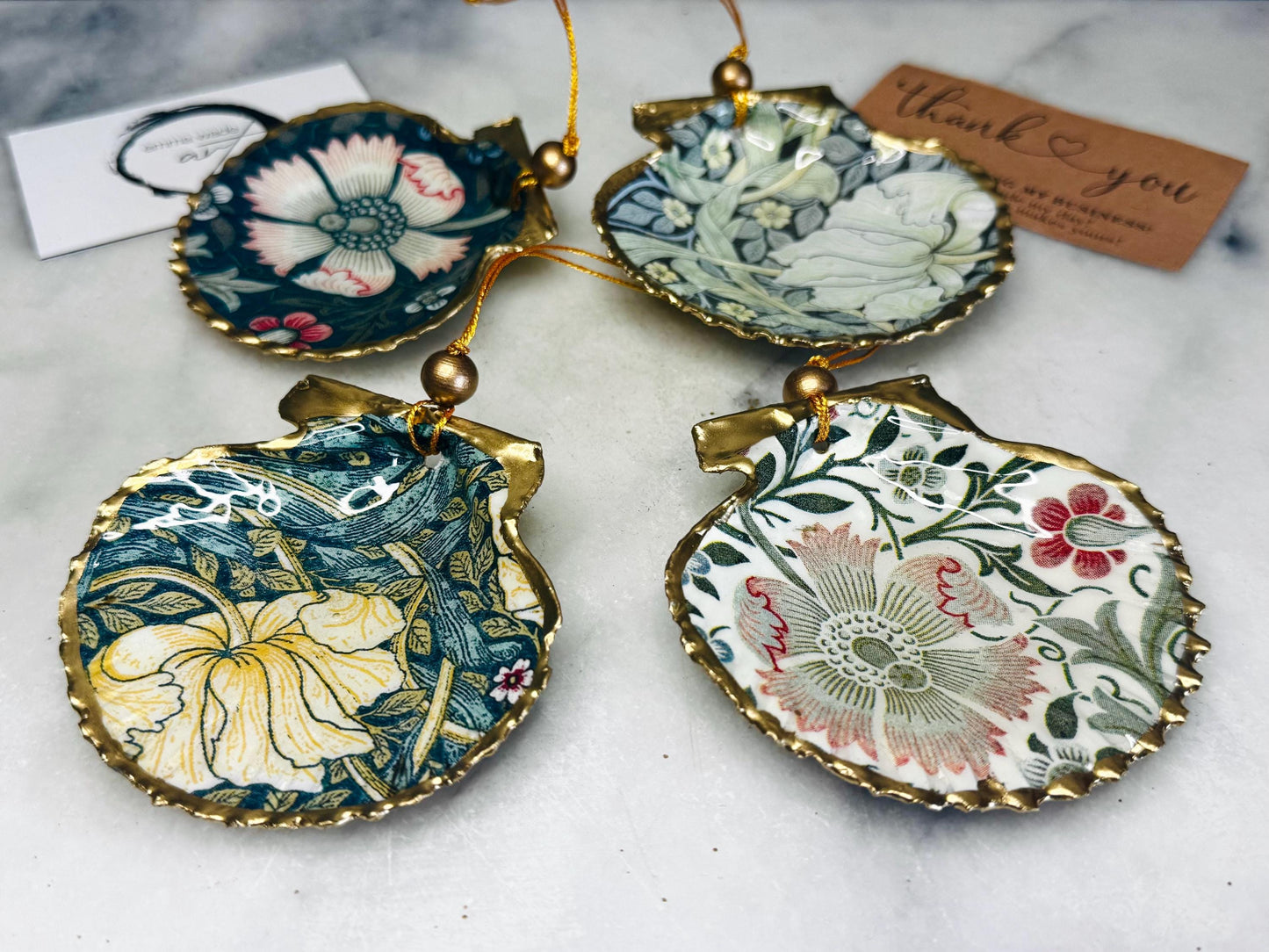 William Morris scallop shell ornaments sold individually or as set of 4, handmade Dorset shells with gold leaf gilded rims and backs, glossy resin interiors, Compton and Pimpernel floral designs, coastal hanging decorations with gold string, sustainable handmade gift, coastal home decor, Christmas ornament or unique shell gift