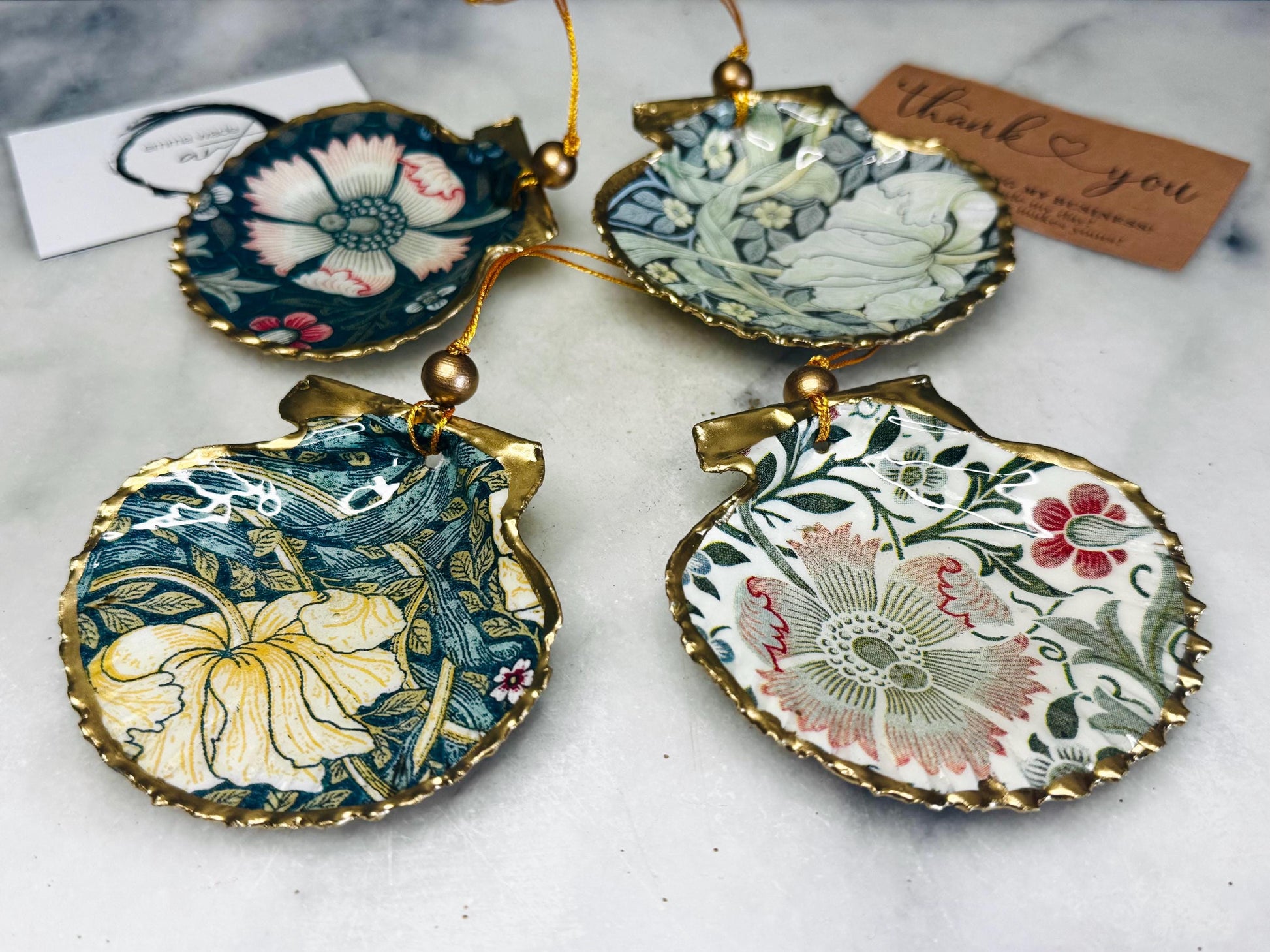 William Morris scallop shell ornaments sold individually or as set of 4, handmade Dorset shells with gold leaf gilded rims and backs, glossy resin interiors, Compton and Pimpernel floral designs, coastal hanging decorations with gold string, sustainable handmade gift, coastal home decor, Christmas ornament or unique shell gift