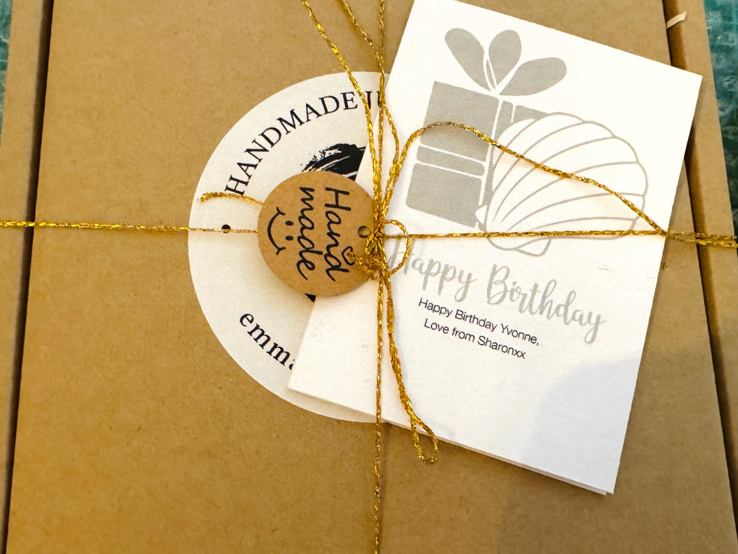 Deep blue watercolour floral scallop shell trinket dish with hand gilded gold leaf edging and glossy resin finish. Handmade Dorset shell jewellery holder in rich cobalt and ocean blue tones, styled as coastal home décor with pearls and gold details. sustainable handmade packing by Emma wade art