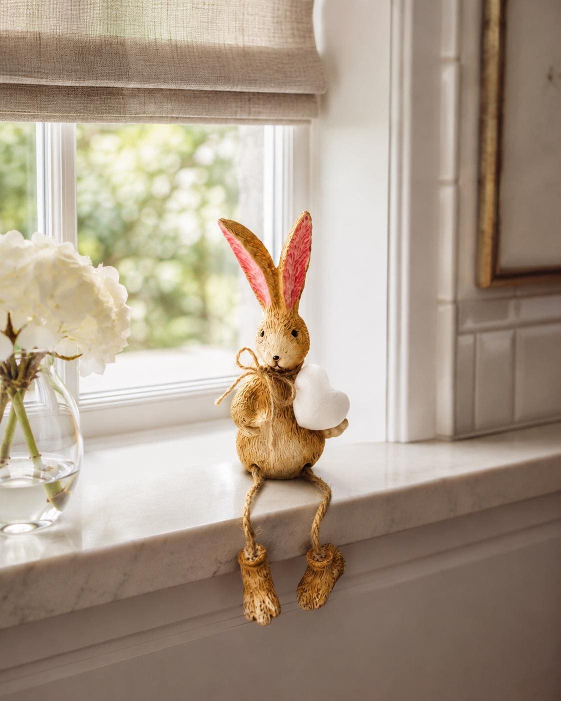Hand finished brown bunny shelf sitter ornament with white heart and dangling jute legs, rustic polyresin rabbit decoration for shelves, mantels, nursery styling or Christmas home decor. Available individually or as a set of 2.