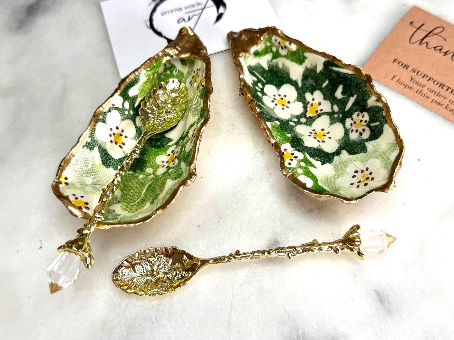 Pair of natural oyster shell salt and pepper pinch pots decorated with green Emma Bridgewater Hawthorn Berry floral design, finished with liquid gold leaf rims and sealed with clear food-safe resin. Optional ornate gold crystal spoons available. Handmade coastal tableware and host gift, suitable for weddings, Christmas dining, dinner parties and new home gifts.