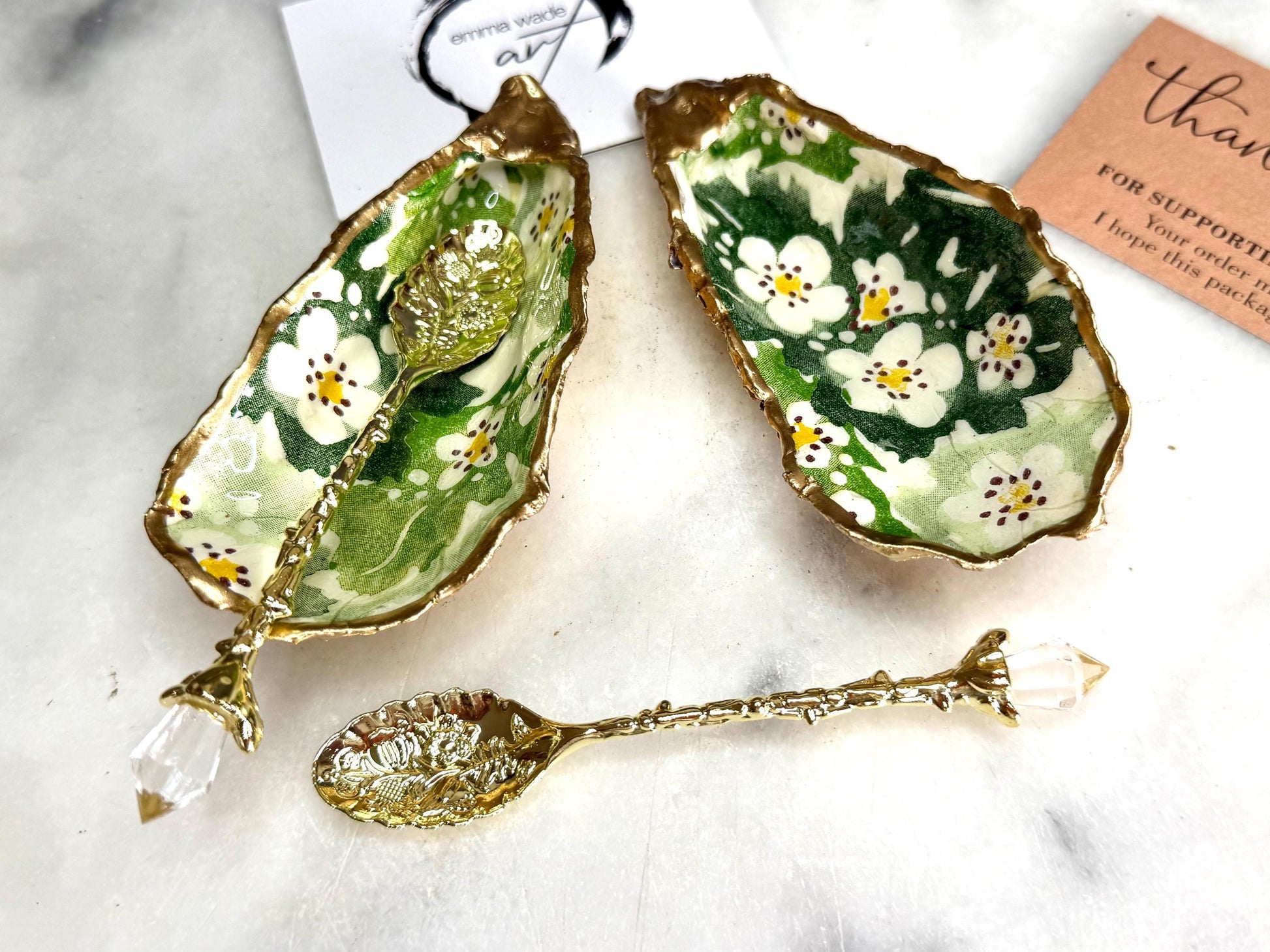Pair of natural oyster shell salt and pepper pinch pots decorated with green Emma Bridgewater Hawthorn Berry floral design, finished with liquid gold leaf rims and sealed with clear food-safe resin. Optional ornate gold crystal spoons available. Handmade coastal tableware and host gift, suitable for weddings, Christmas dining, dinner parties and new home gifts.