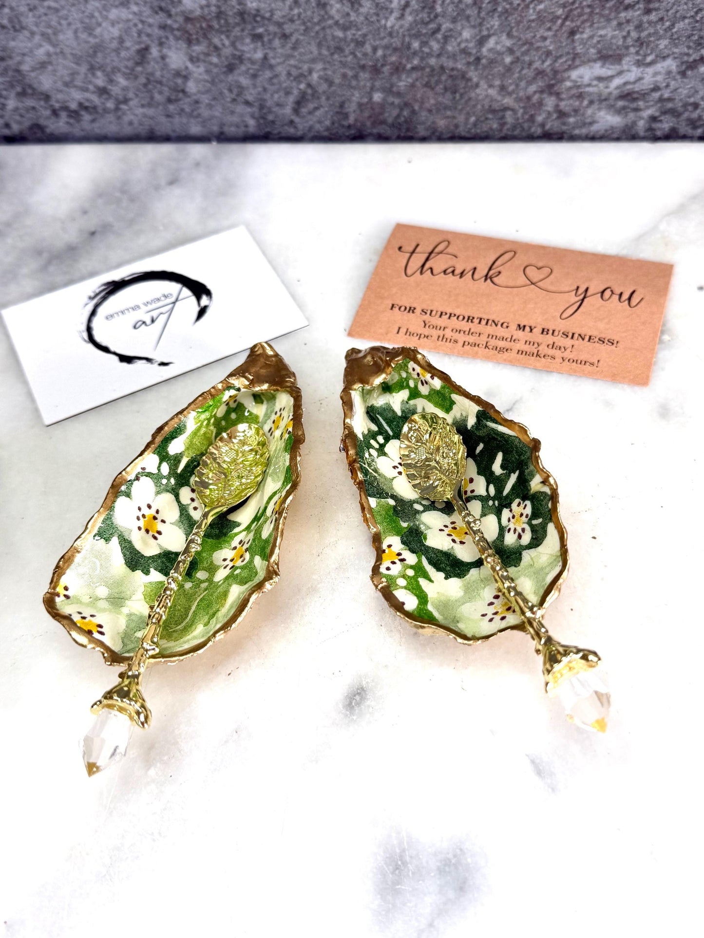 Pair of natural oyster shell salt and pepper pinch pots decorated with green Emma Bridgewater Hawthorn Berry floral design, finished with liquid gold leaf rims and sealed with clear food-safe resin. Optional ornate gold crystal spoons available. Handmade coastal tableware and host gift, suitable for weddings, Christmas dining, dinner parties and new home gifts.
