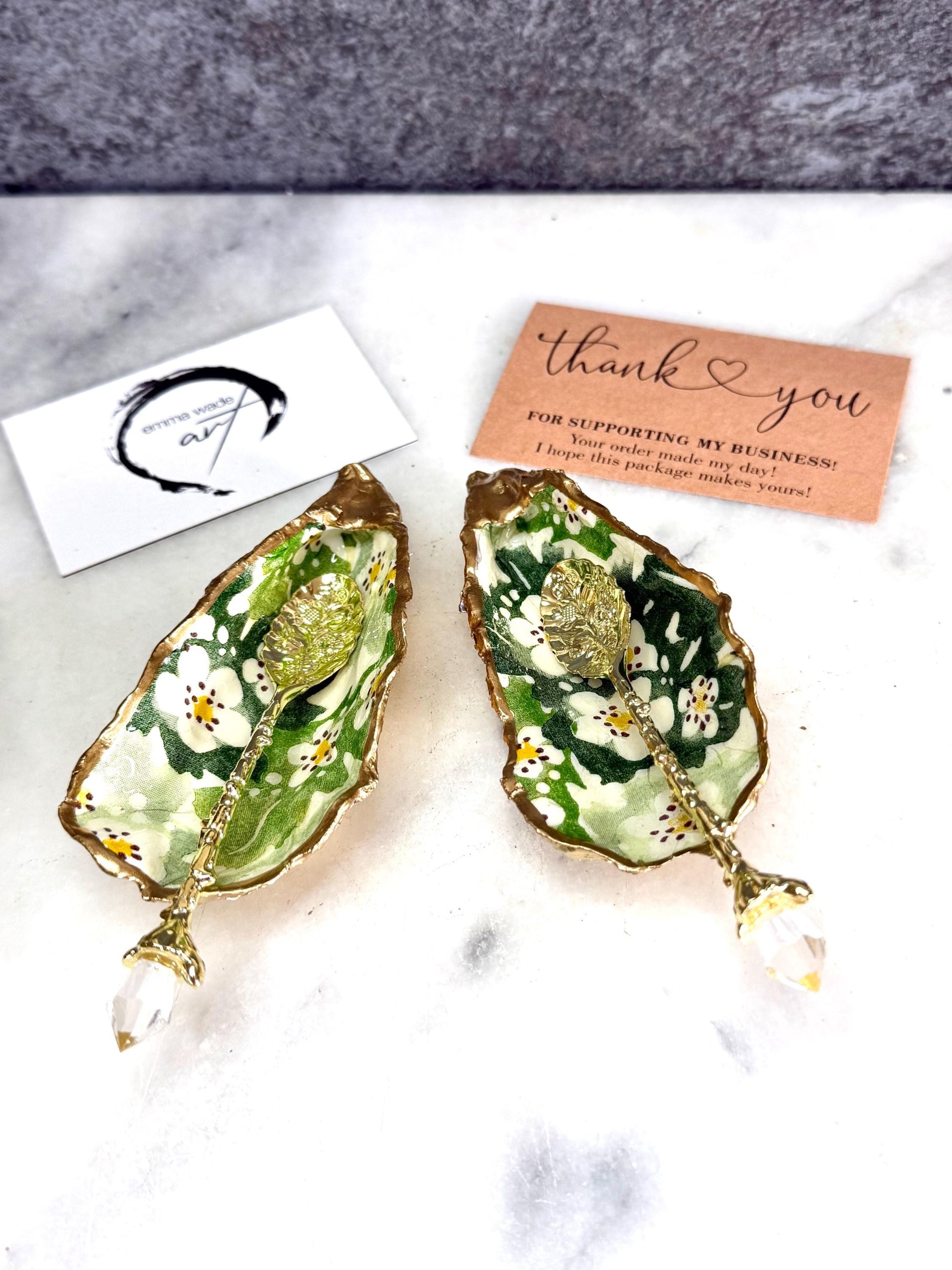 Pair of natural oyster shell salt and pepper pinch pots decorated with green Emma Bridgewater Hawthorn Berry floral design, finished with liquid gold leaf rims and sealed with clear food-safe resin. Optional ornate gold crystal spoons available. Handmade coastal tableware and host gift, suitable for weddings, Christmas dining, dinner parties and new home gifts.