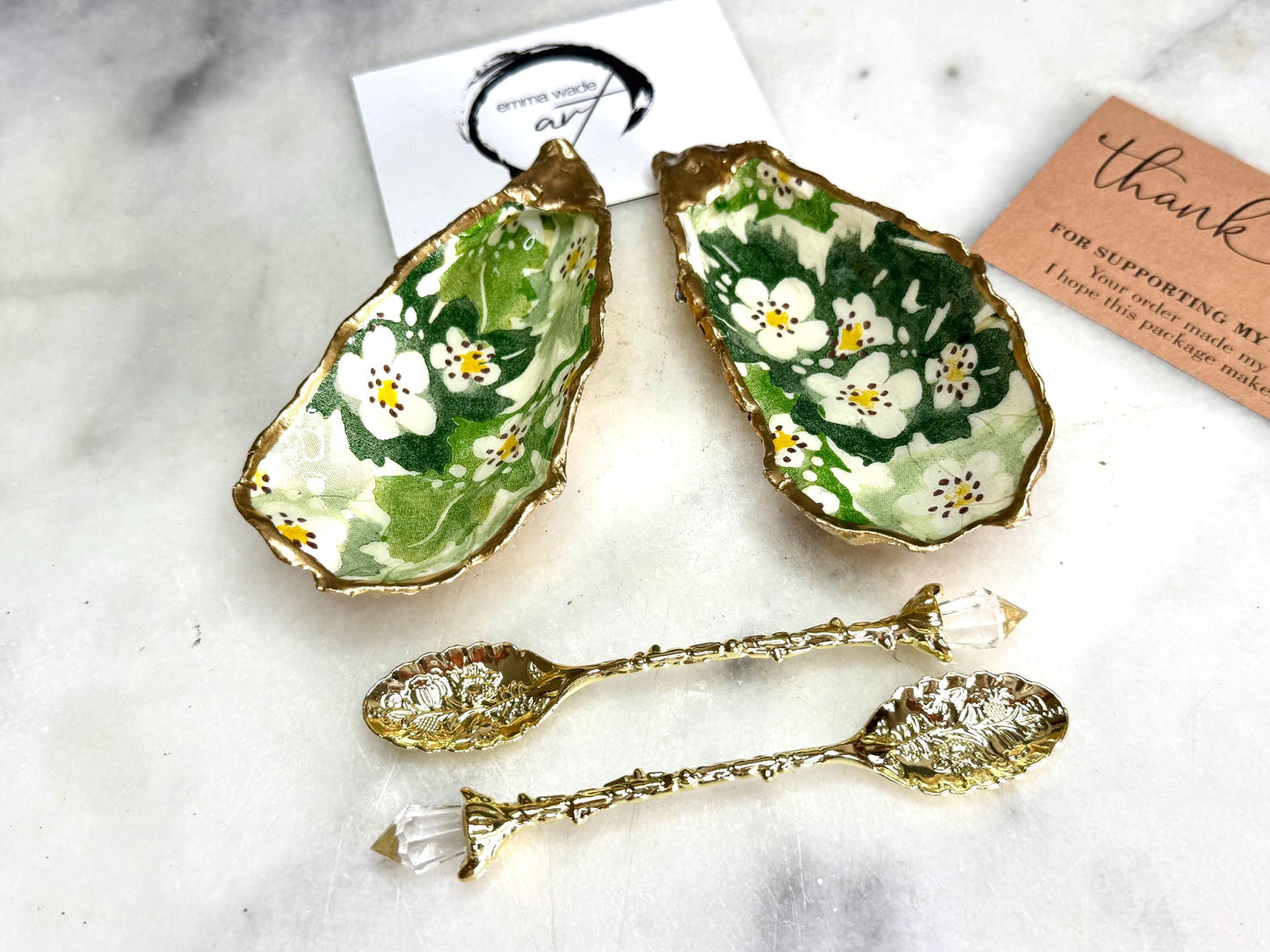 Pair of natural oyster shell salt and pepper pinch pots decorated with green Emma Bridgewater Hawthorn Berry floral design, finished with liquid gold leaf rims and sealed with clear food-safe resin. Optional ornate gold crystal spoons available. Handmade coastal tableware and host gift, suitable for weddings, Christmas dining, dinner parties and new home gifts.