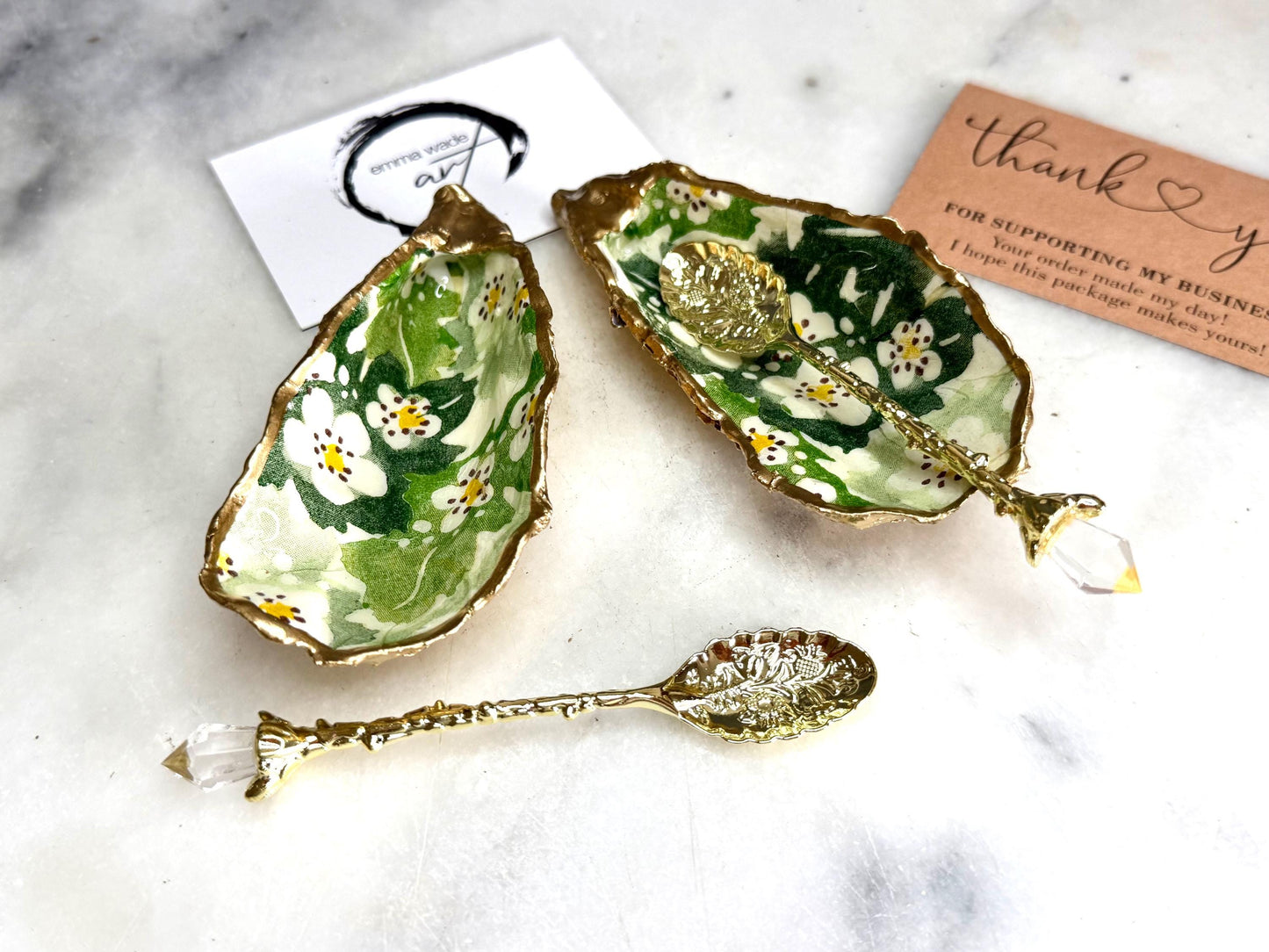 Pair of natural oyster shell salt and pepper pinch pots decorated with green Emma Bridgewater Hawthorn Berry floral design, finished with liquid gold leaf rims and sealed with clear food-safe resin. Optional ornate gold crystal spoons available. Handmade coastal tableware and host gift, suitable for weddings, Christmas dining, dinner parties and new home gifts.
