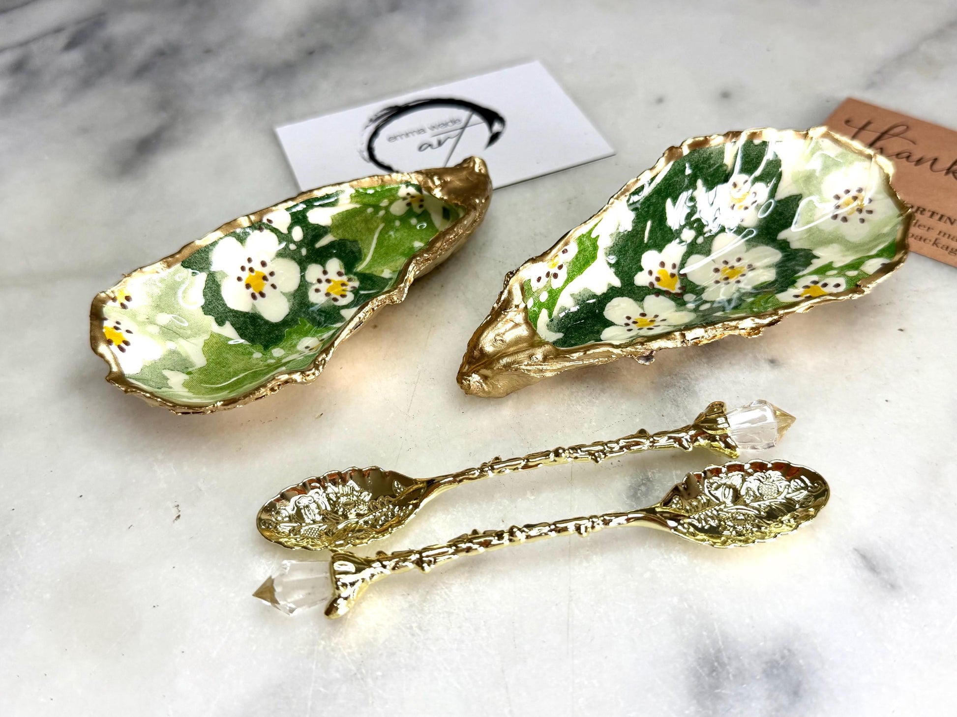 Pair of natural oyster shell salt and pepper pinch pots decorated with green Emma Bridgewater Hawthorn Berry floral design, finished with liquid gold leaf rims and sealed with clear food-safe resin. Optional ornate gold crystal spoons available. Handmade coastal tableware and host gift, suitable for weddings, Christmas dining, dinner parties and new home gifts.