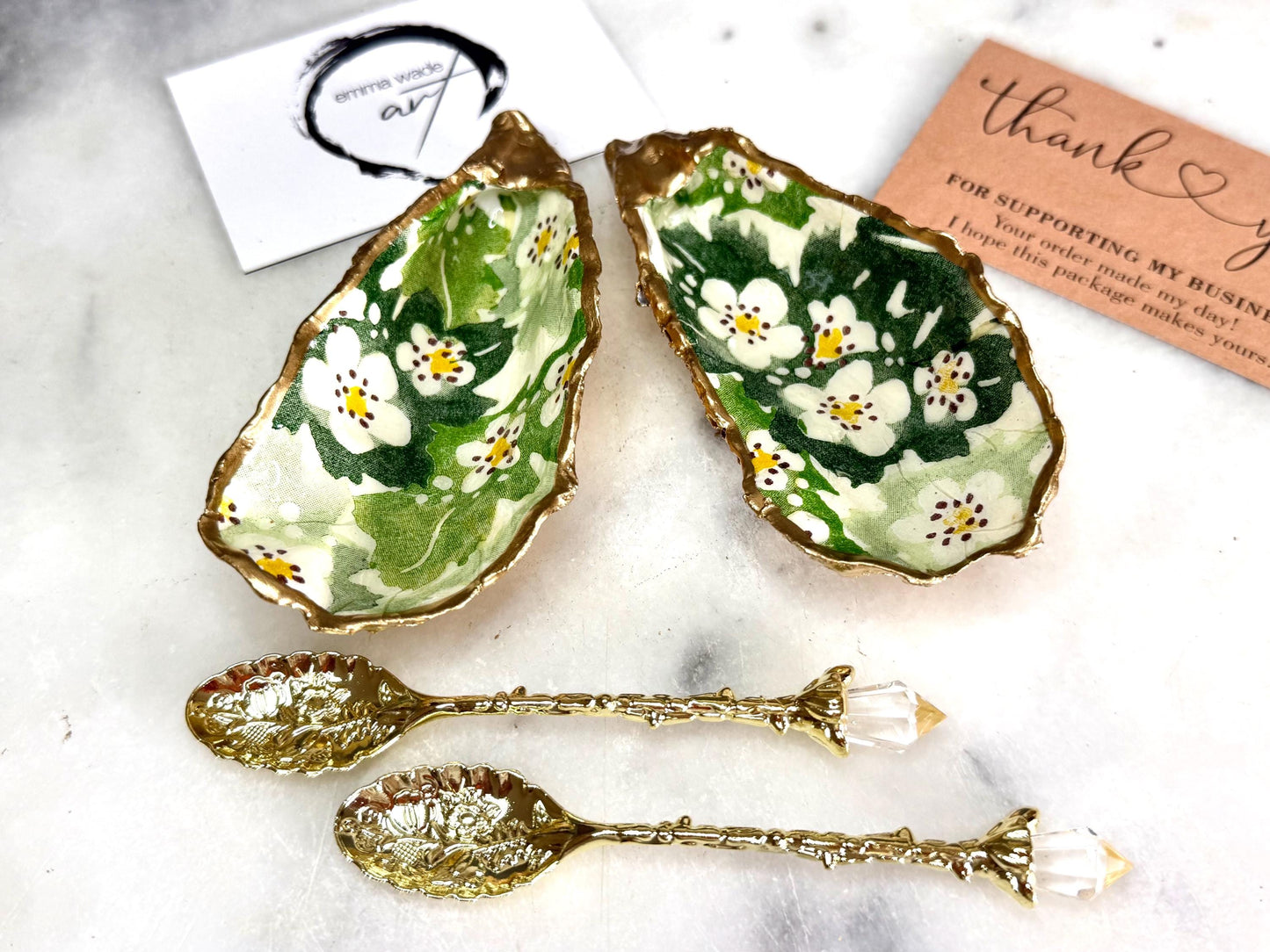 Pair of natural oyster shell salt and pepper pinch pots decorated with green Emma Bridgewater Hawthorn Berry floral design, finished with liquid gold leaf rims and sealed with clear food-safe resin. Optional ornate gold crystal spoons available. Handmade coastal tableware and host gift, suitable for weddings, Christmas dining, dinner parties and new home gifts.