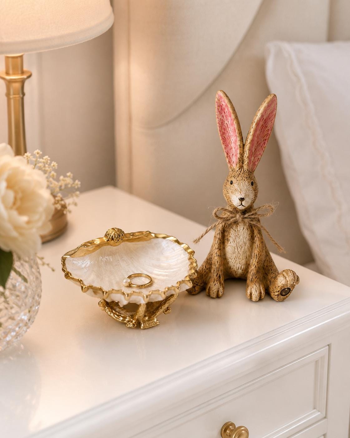 Hand finished brown Christmas rabbit ornament with soft pink inner ears and a rustic jute bow. Single resin bunny decoration sold individually, styled as festive shelf decor for a mantelpiece, console table or woodland Christmas display. Rustic country home ornament and Christmas gift for rabbit lovers.