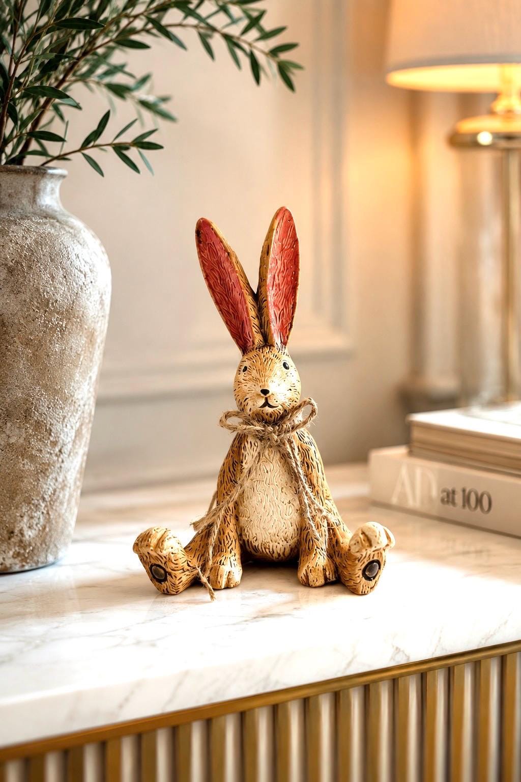 Hand finished polyresin Christmas bunny ornaments with rustic jute bows and soft pink inner ears. Decorative rabbit shelf ornaments shown as a seated bunny and two bunnies kissing, available individually or as a set. Festive woodland-style decor for Christmas shelves, mantelpieces, cottage interiors and rabbit lover gifts.