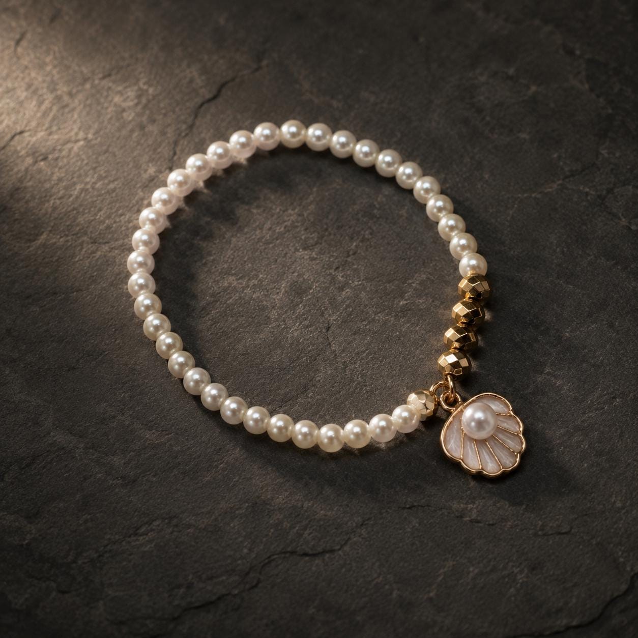 Set of three delicate coastal stretch bracelets featuring small ivory faux pearls and gold-tone seaside details. The coordinating jewellery set includes a blush enamel-style scallop shell charm with pearl centre, a textured gold starfish charm and a ridged gold shell centrepiece with pale champagne faceted beads. Lightweight 16 cm elasticated bohemian costume jewellery for coastal gifts, Christmas presents, stocking fillers, holidays, beach weddings, bridesmaids and gifts for her.
