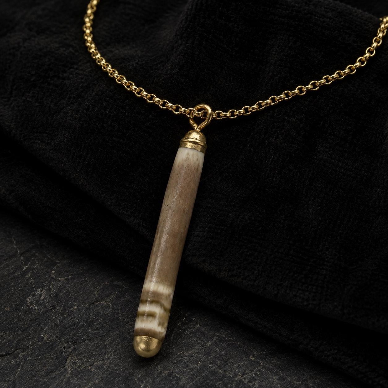 Handmade pencil-urchin spine necklace arranged on a dark luxury background with an 18K gold-plated chain and liquid-gold detail