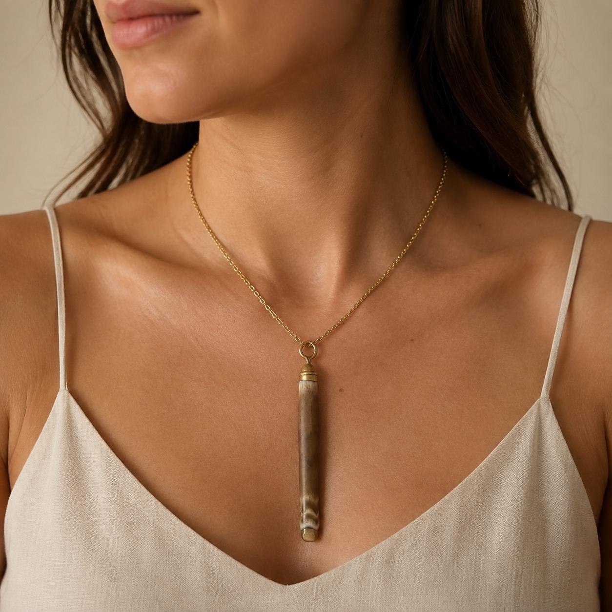 Handmade natural sea-urchin spine necklace displayed on a white jewellery bust with liquid gold leaf at both ends and an 18-inch 18K gold-plated chain.