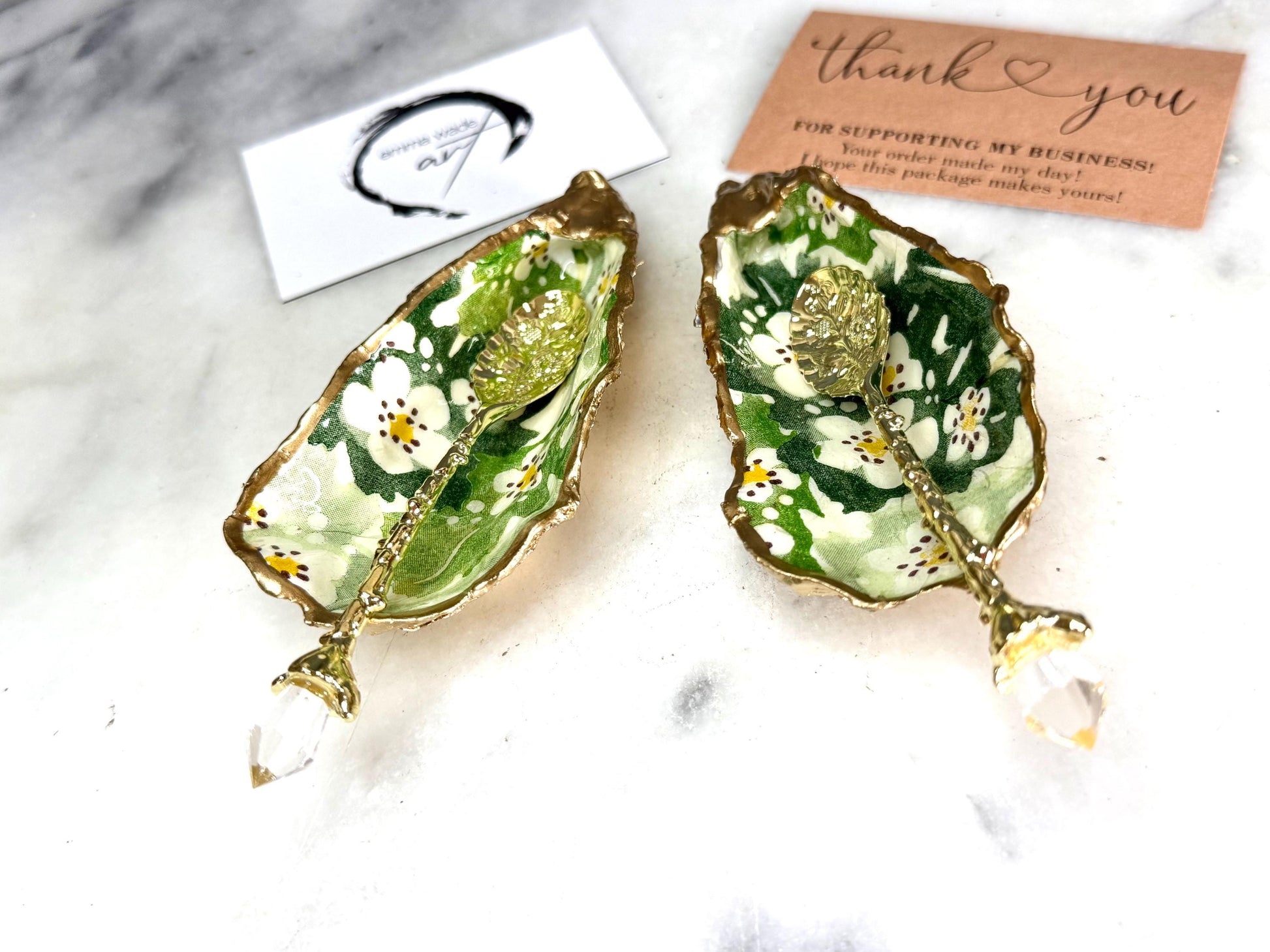 Pair of natural oyster shell salt and pepper pinch pots decorated with green Emma Bridgewater Hawthorn Berry floral design, finished with liquid gold leaf rims and sealed with clear food-safe resin. Optional ornate gold crystal spoons available. Handmade coastal tableware and host gift, suitable for weddings, Christmas dining, dinner parties and new home gifts.