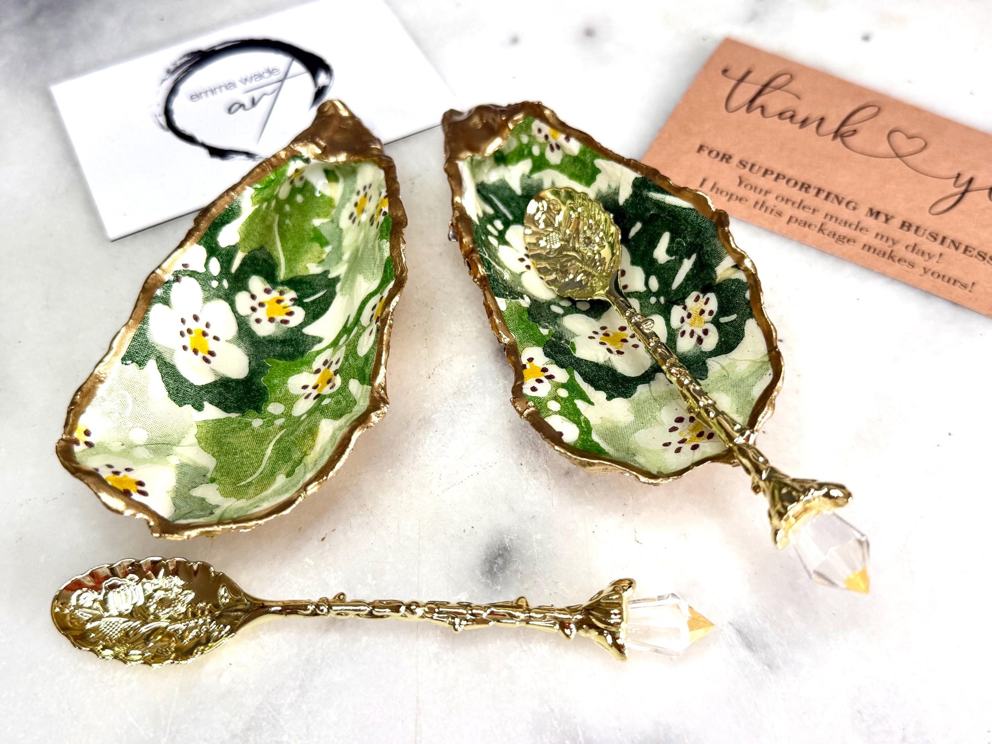 Pair of natural oyster shell salt and pepper pinch pots decorated with green Emma Bridgewater Hawthorn Berry floral design, finished with liquid gold leaf rims and sealed with clear food-safe resin. Optional ornate gold crystal spoons available. Handmade coastal tableware and host gift, suitable for weddings, Christmas dining, dinner parties and new home gifts.