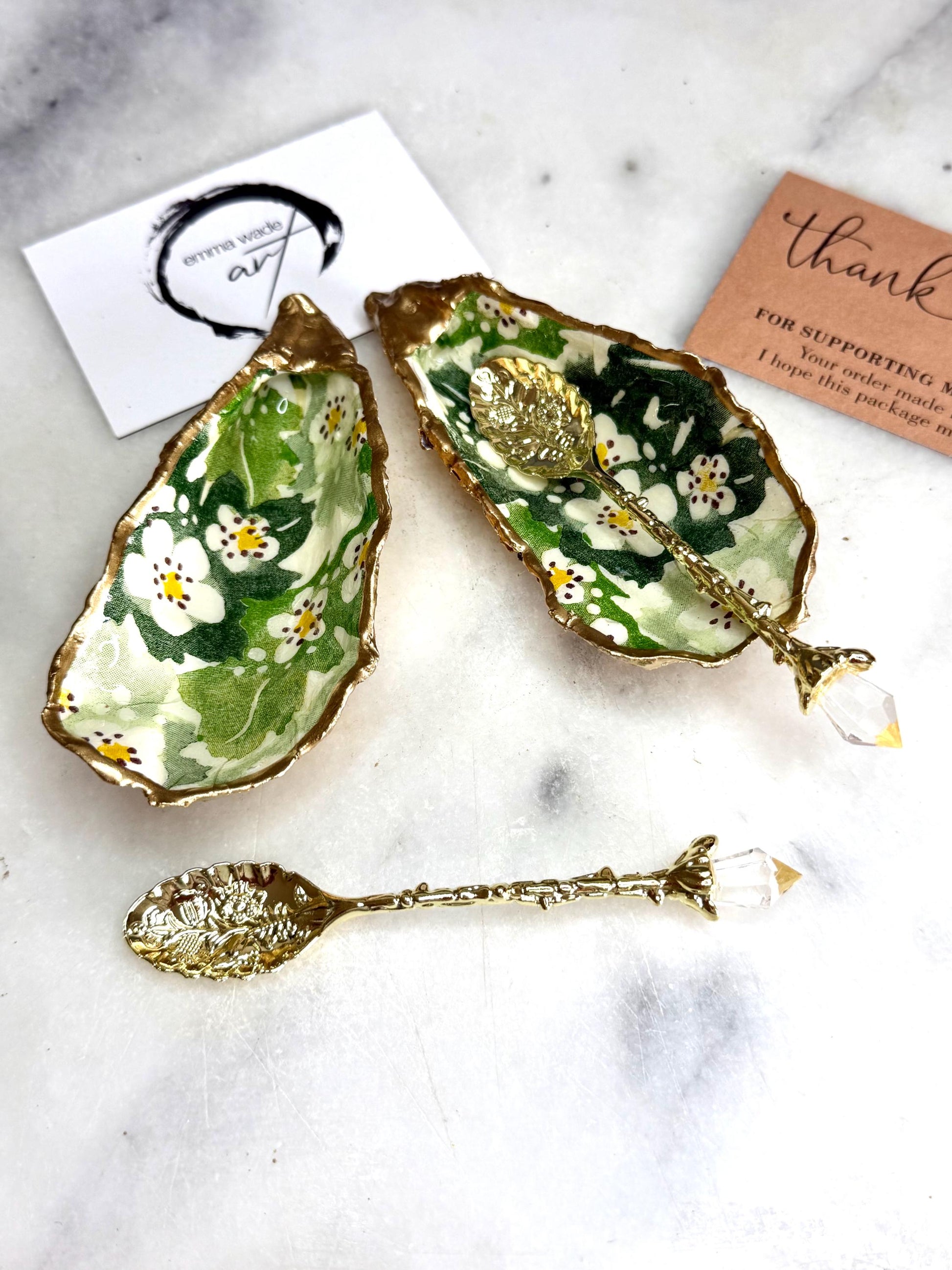 Pair of natural oyster shell salt and pepper pinch pots decorated with green Emma Bridgewater Hawthorn Berry floral design, finished with liquid gold leaf rims and sealed with clear food-safe resin. Optional ornate gold crystal spoons available. Handmade coastal tableware and host gift, suitable for weddings, Christmas dining, dinner parties and new home gifts.