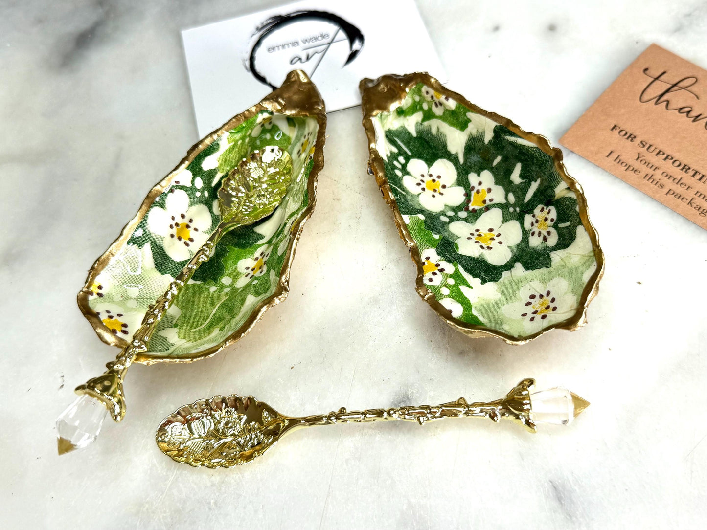 Pair of natural oyster shell salt and pepper pinch pots decorated with green Emma Bridgewater Hawthorn Berry floral design, finished with liquid gold leaf rims and sealed with clear food-safe resin. Optional ornate gold crystal spoons available. Handmade coastal tableware and host gift, suitable for weddings, Christmas dining, dinner parties and new home gifts.